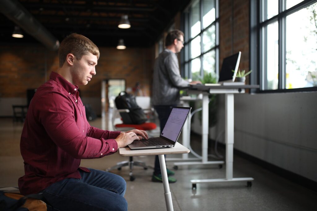 man working at standing desk